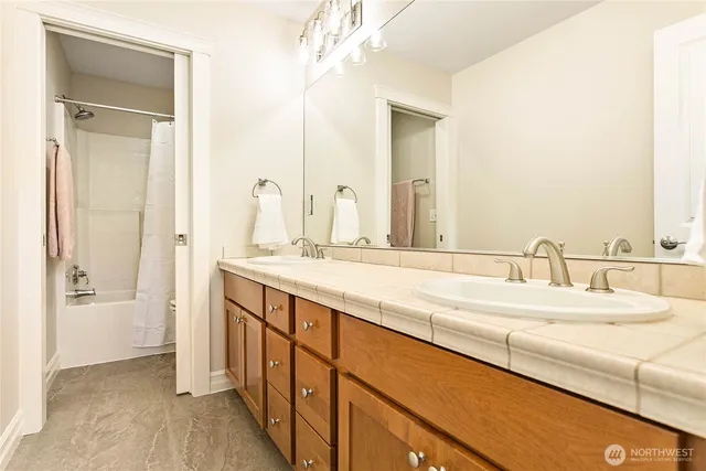a bathroom with a double vanity sink and a mirror