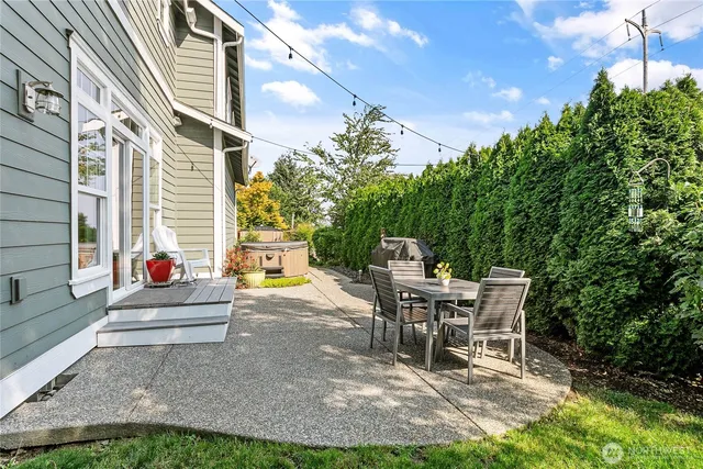 a view of a patio with a table and chairs and potted plants