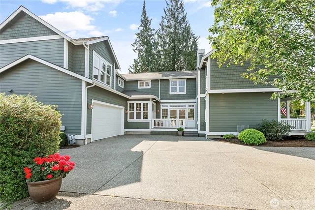 a front view of a house with a garden and plants