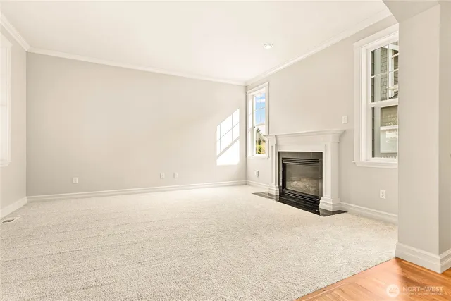 a view of empty room with a fireplace