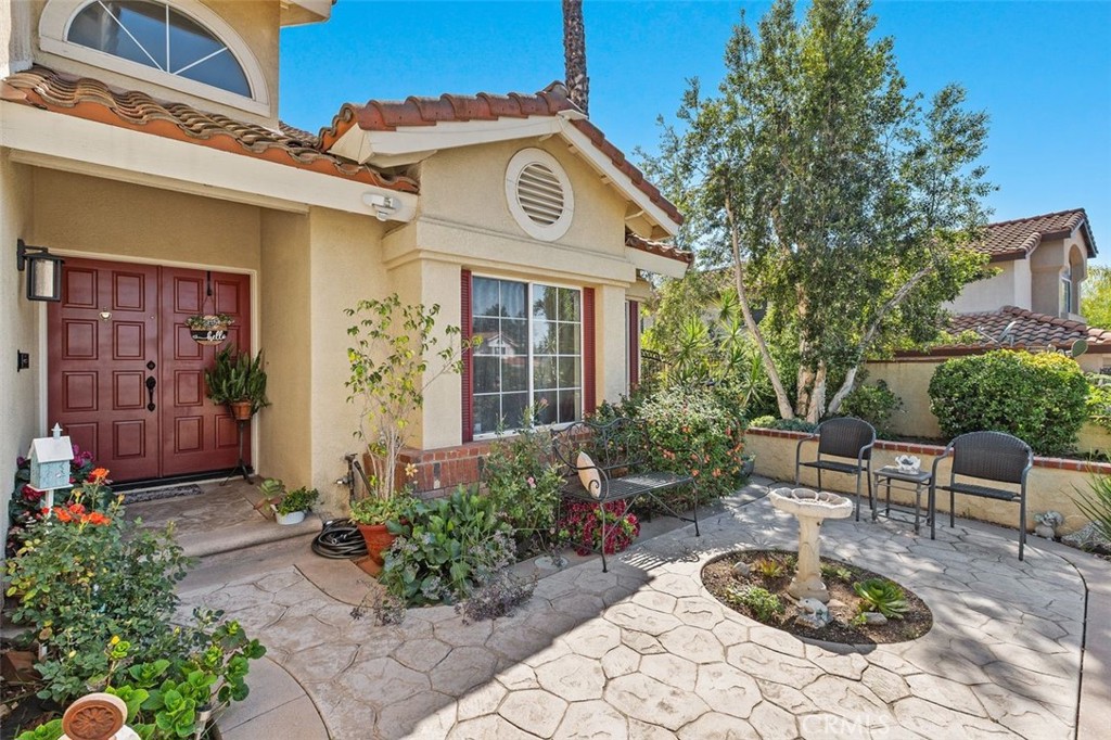 305 Mission Grove Parkway North Riverside, CA 92506 - Photo 13 of 49 a view of a brick house with potted plants and a bench