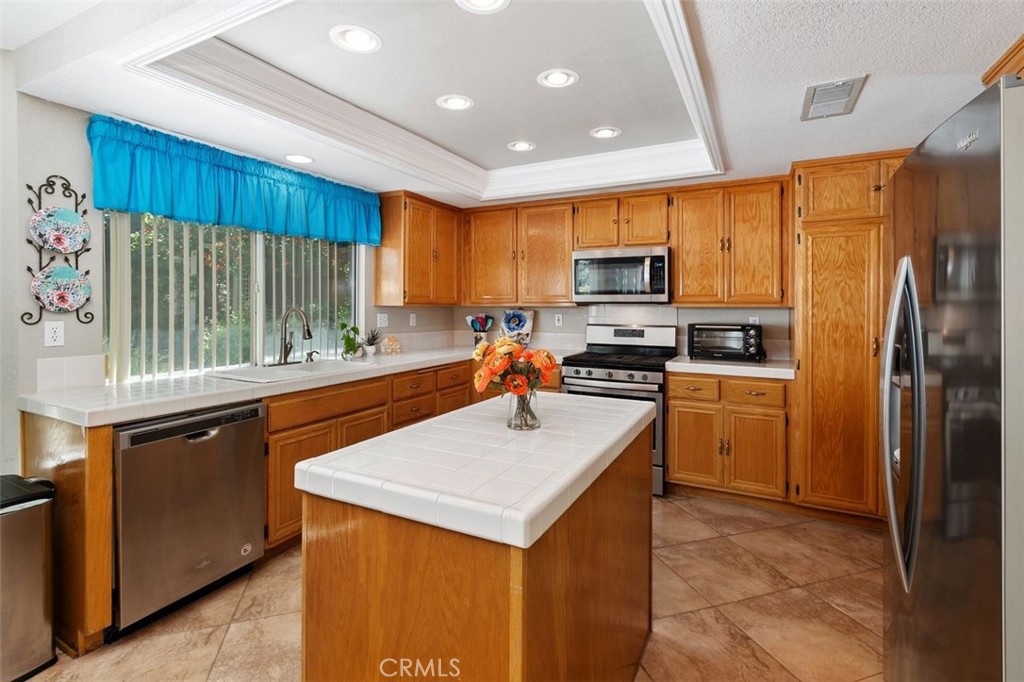 305 Mission Grove Parkway North Riverside, CA 92506 - Photo 25 of 49 a kitchen with kitchen island granite countertop a refrigerator stove top oven and sink