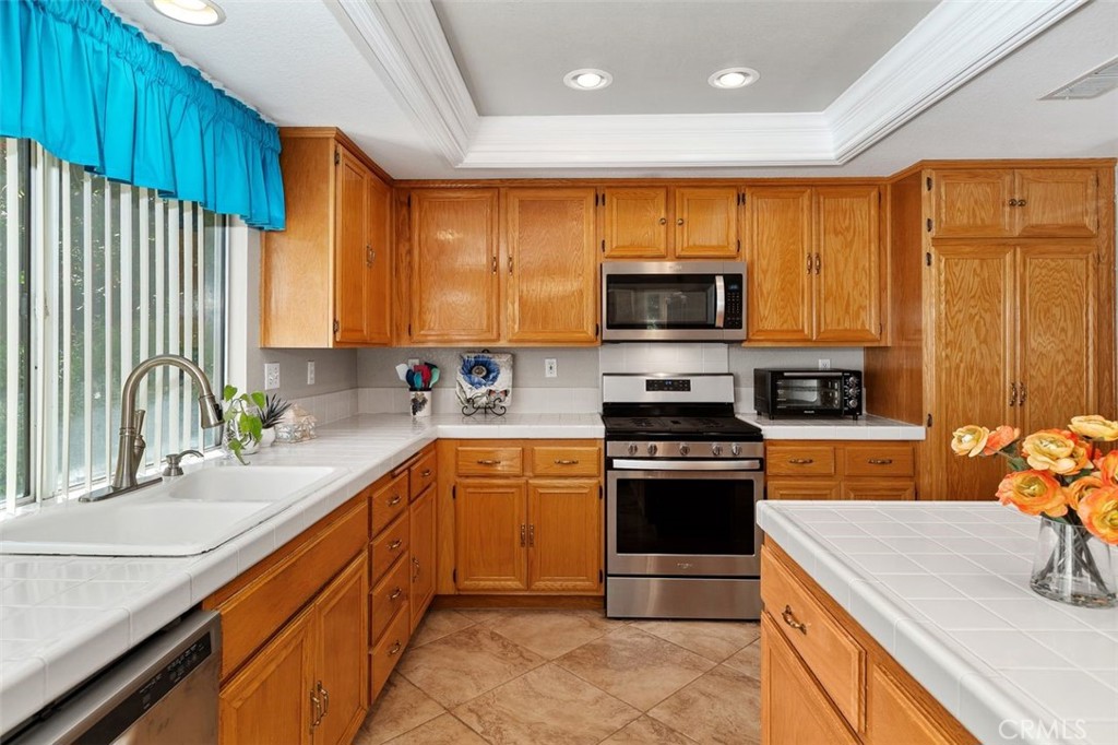305 Mission Grove Parkway North Riverside, CA 92506 - Photo 26 of 49 a kitchen with stainless steel appliances granite countertop a stove a sink and a microwave