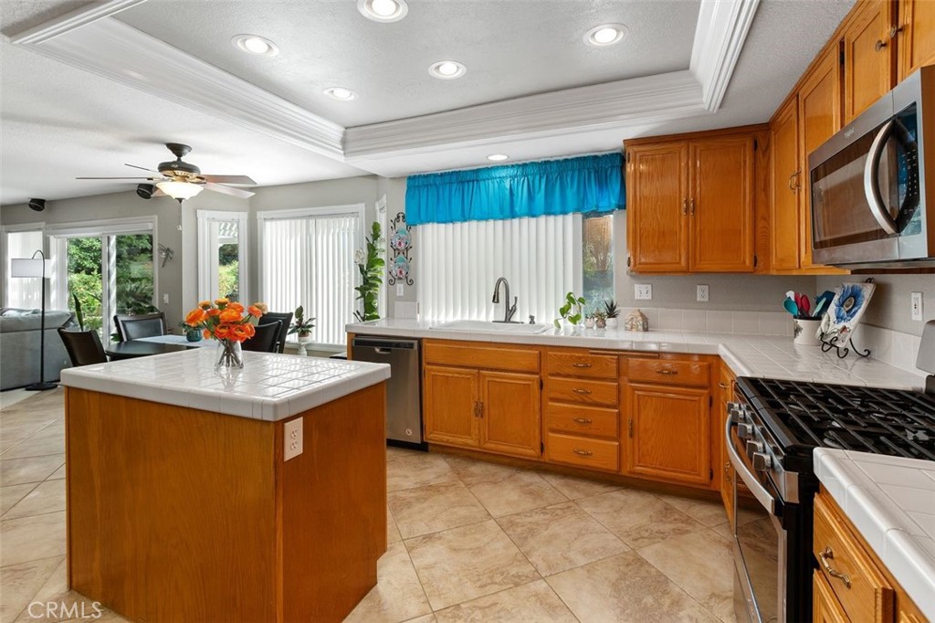305 Mission Grove Parkway North Riverside, CA 92506 - Photo 27 of 49 a kitchen with stainless steel appliances granite countertop a sink and a refrigerator