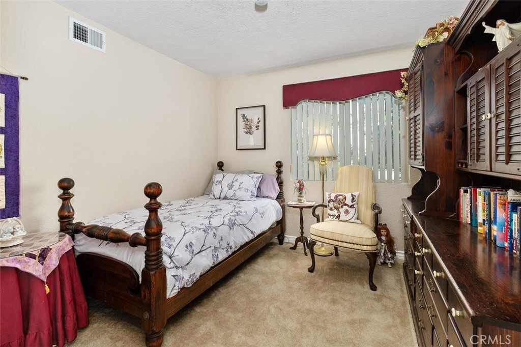 305 Mission Grove Parkway North Riverside, CA 92506 - Photo 29 of 49 a bedroom with a bed and a book shelf