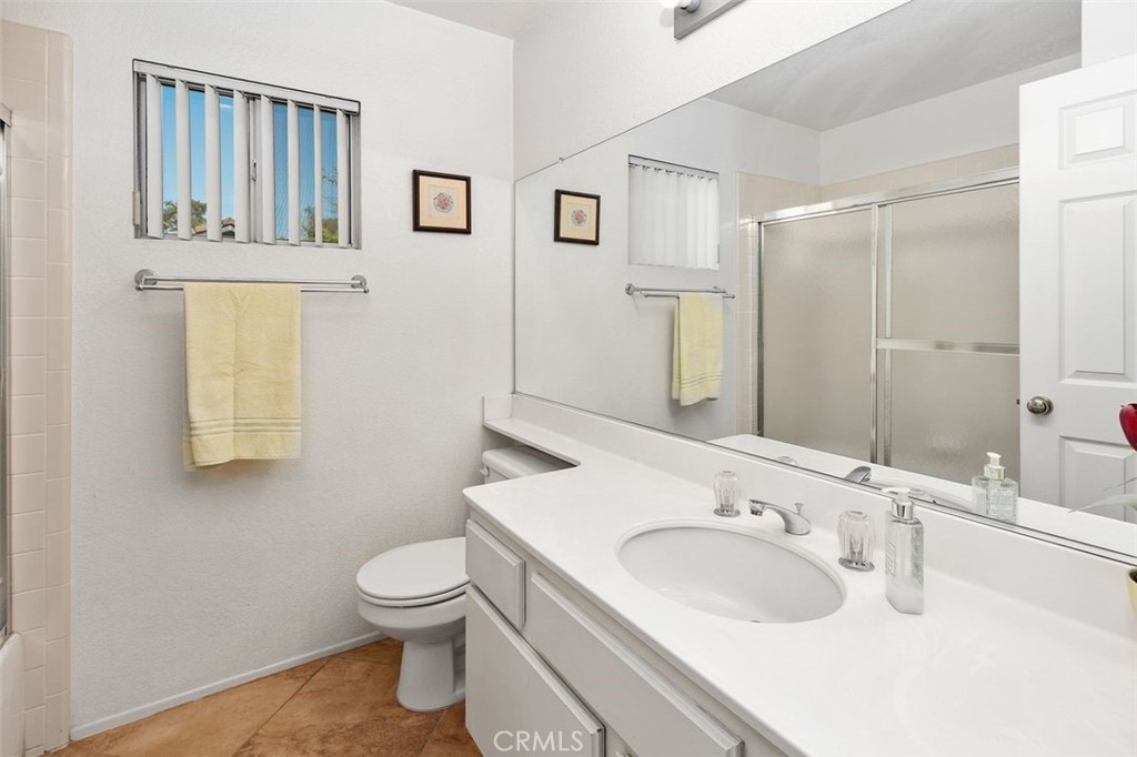 305 Mission Grove Parkway North Riverside, CA 92506 - Photo 36 of 49 a bathroom with a toilet a sink and mirror