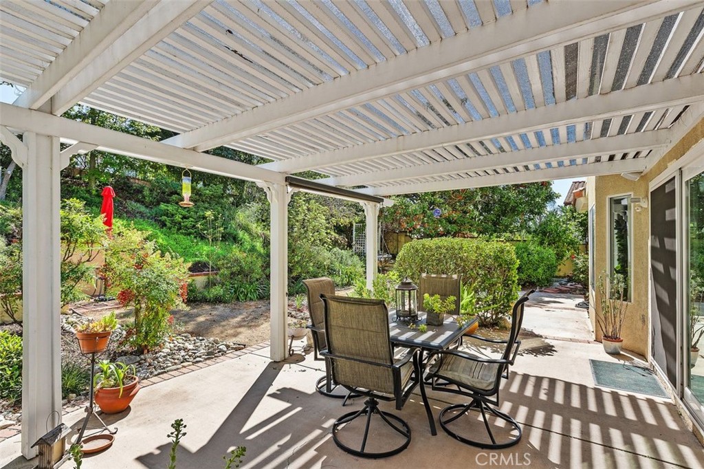 305 Mission Grove Parkway North Riverside, CA 92506 - Photo 45 of 49 a view of a patio with table and chairs potted plants and floor to ceiling window with garden view