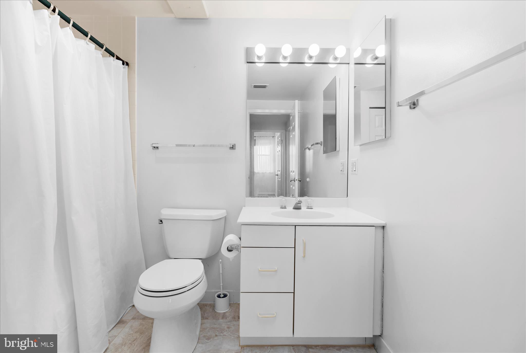 930 Astern Way, Unit 512 Annapolis, MD 21401 - Photo 18 of 58 a bathroom with a toilet a sink and a mirror