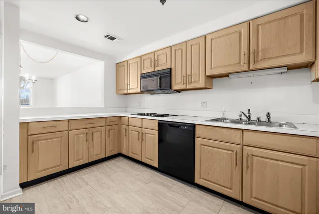 a kitchen with stainless steel appliances a stove a sink a refrigerator and cabinets