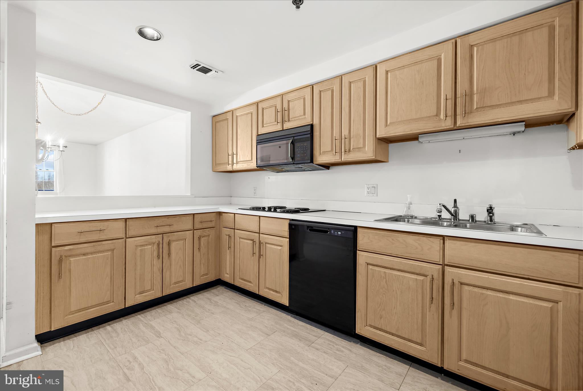930 Astern Way, Unit 512 Annapolis, MD 21401 - Photo 7 of 58 a kitchen with sink cabinets and microwave