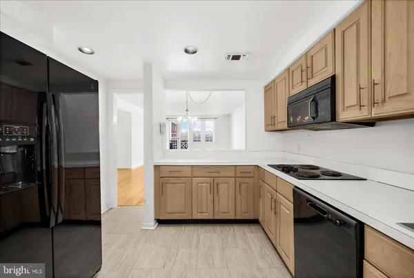 a kitchen with stainless steel appliances a sink cabinets and wooden floor