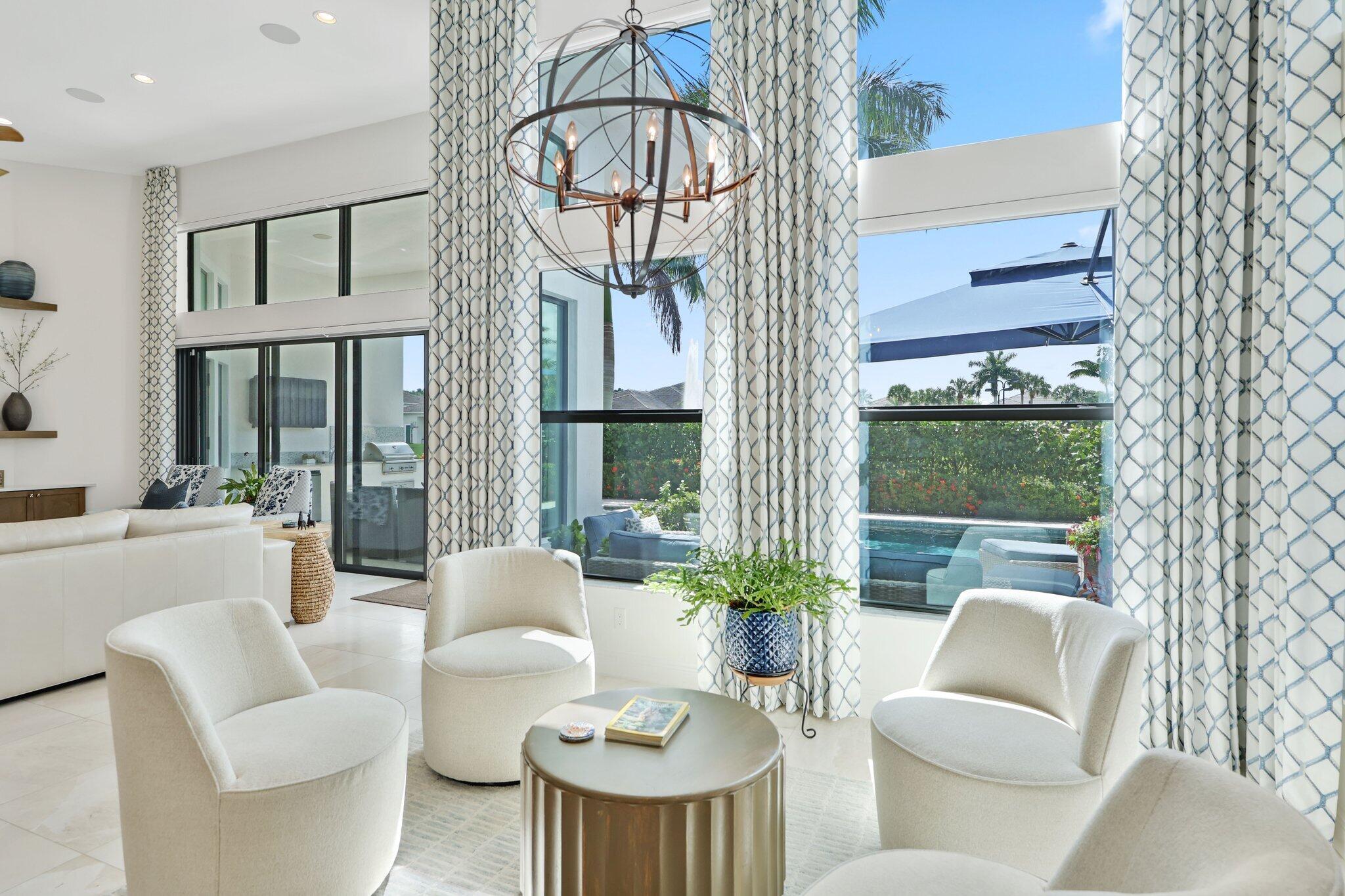 2530 Northwest 71st Street Boca Raton, FL 33496 - Photo 18 of 94 a living room with furniture a floor to ceiling window and potted plants