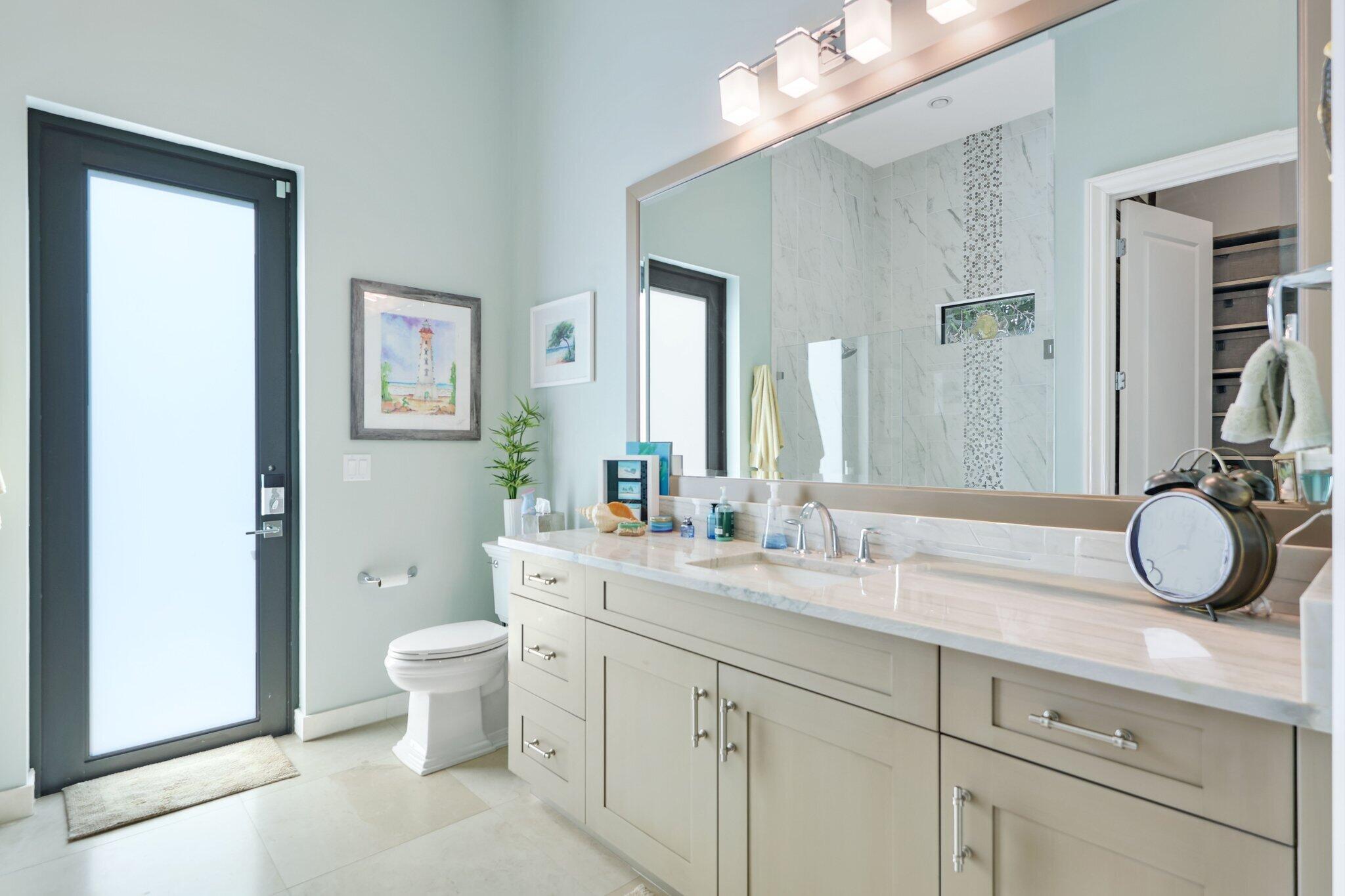 2530 Northwest 71st Street Boca Raton, FL 33496 - Photo 28 of 94 a bathroom with a granite countertop sink mirror vanity and toilet