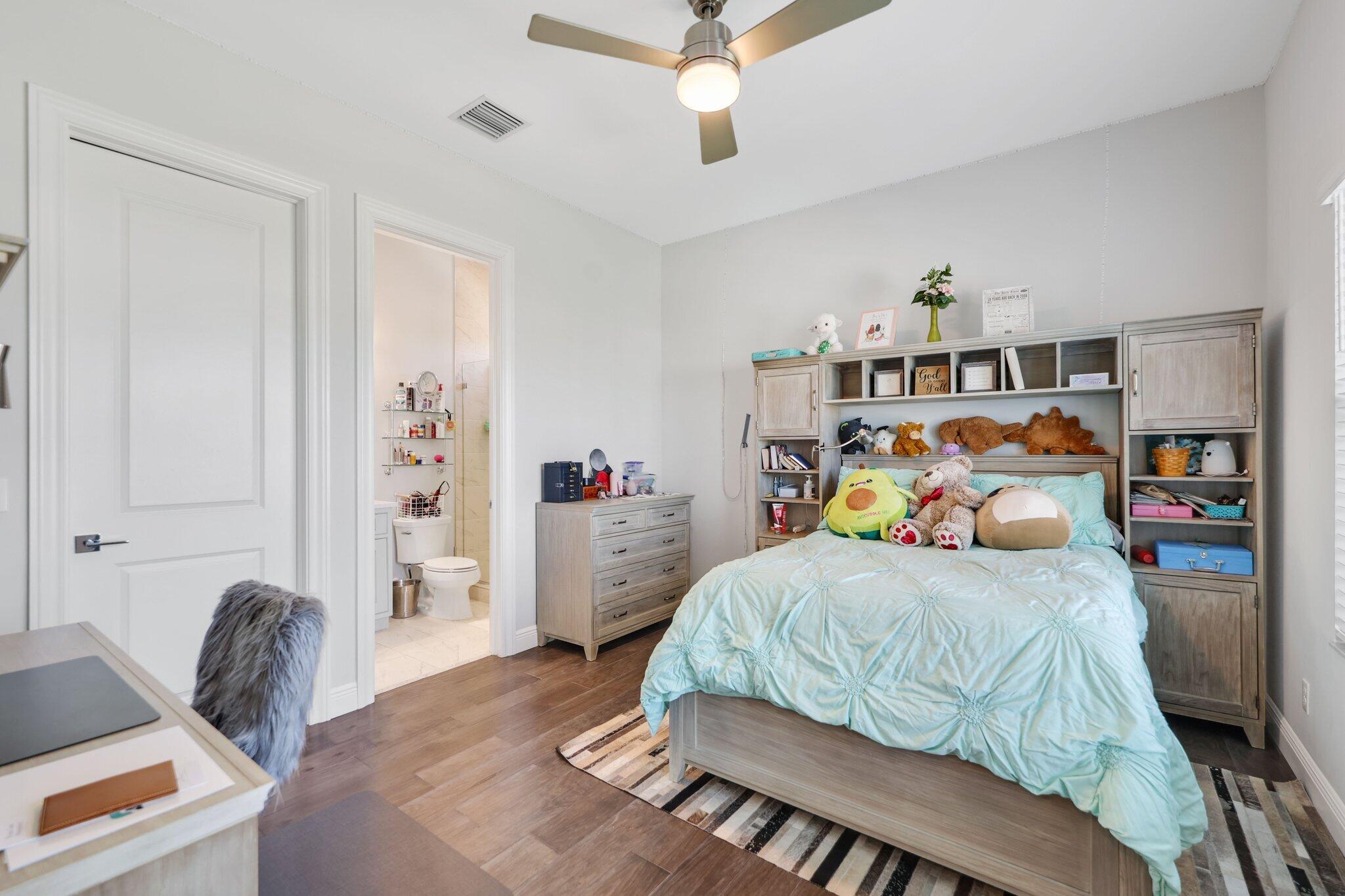 2530 Northwest 71st Street Boca Raton, FL 33496 - Photo 46 of 94 a bedroom with a bed and furniture