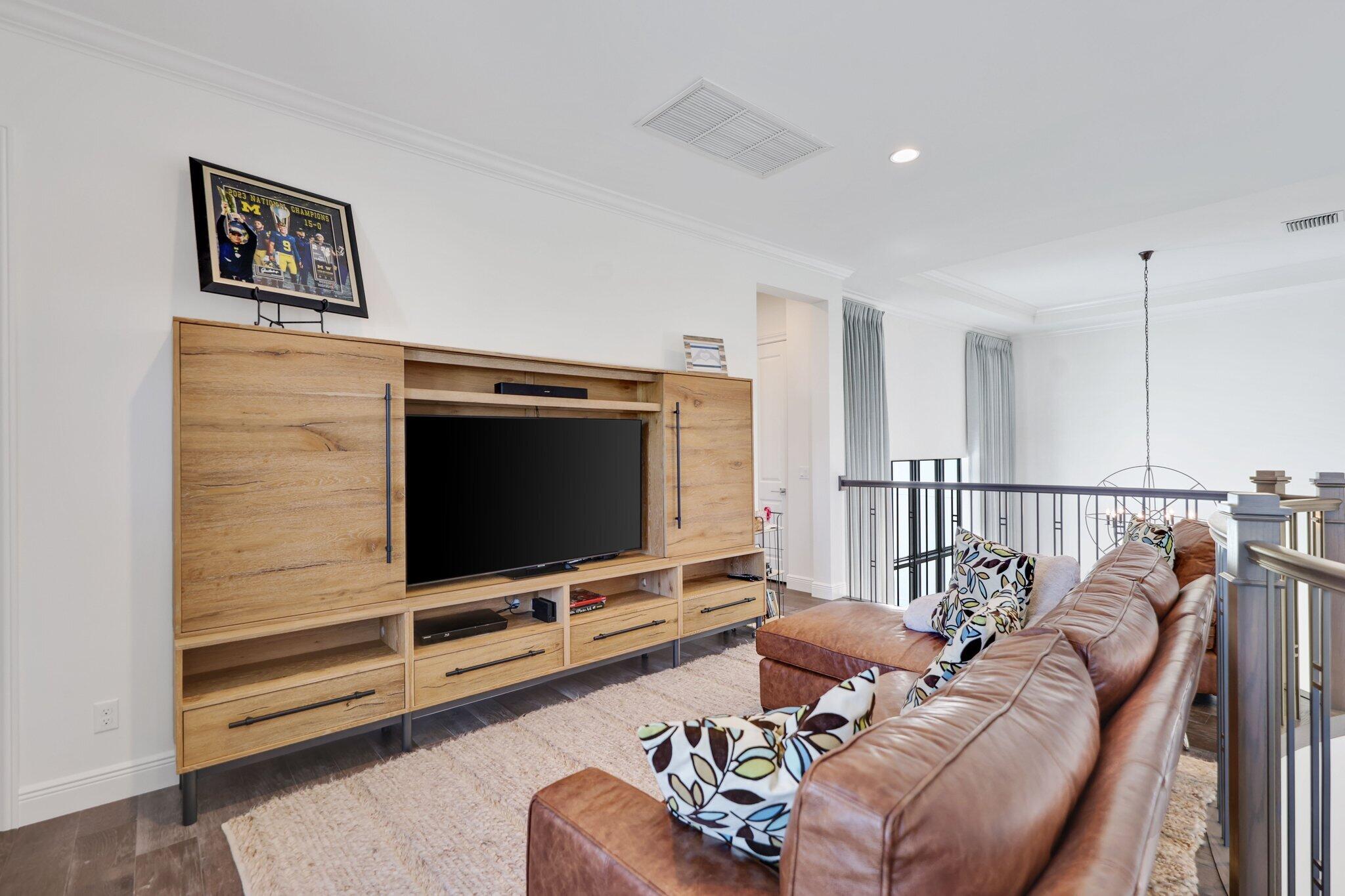 2530 Northwest 71st Street Boca Raton, FL 33496 - Photo 50 of 94 a living room with furniture and a flat screen tv