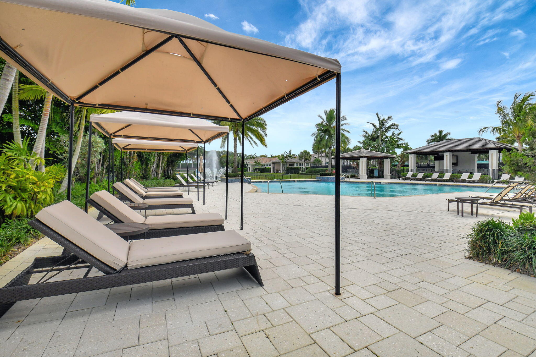 2530 Northwest 71st Street Boca Raton, FL 33496 - Photo 78 of 94 a view of a patio with a table and chairs under an umbrella