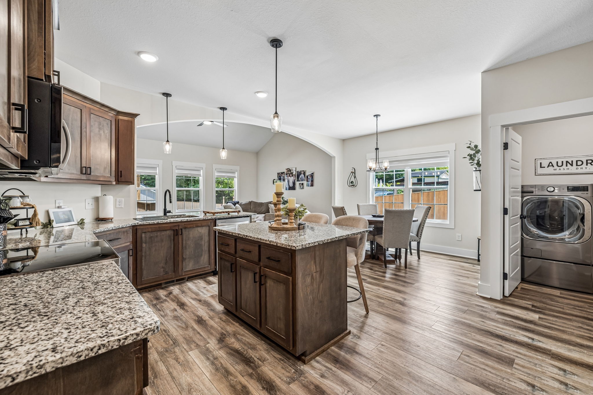 1845 Dinsmore Road Clarksville, TN 37040 - Photo 8 of 36 a kitchen with stainless steel appliances granite countertop a stove top oven a refrigerator a sink and a dining table with wooden floor