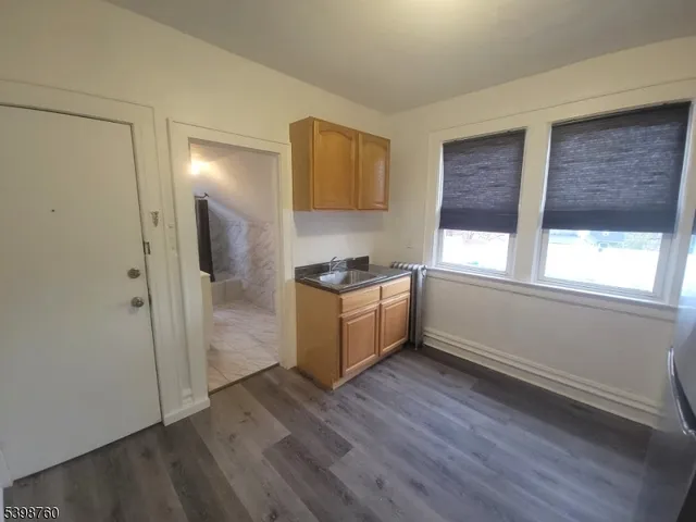 a kitchen with a refrigerator and window
