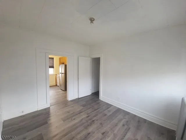 a view of a room with wooden floor and a sink