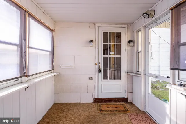 a view of a hallway with wooden staircase