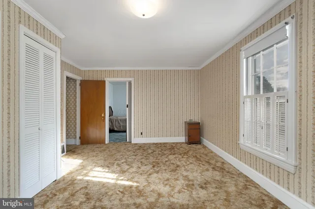 a bedroom with a bed and a refrigerator