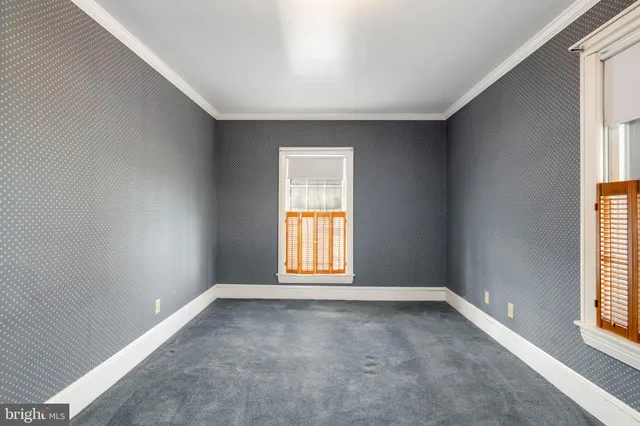 an empty room with windows and closet