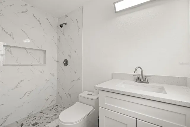 a bathroom with a sink toilet and shower
