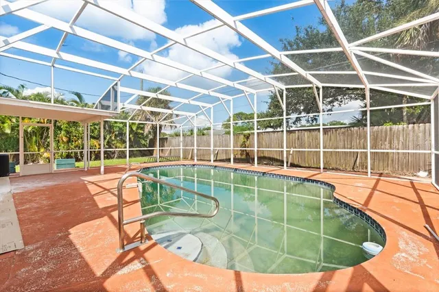 a view of a swimming pool with a floor to ceiling window and stairs