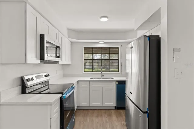 a kitchen with a sink stove and refrigerator