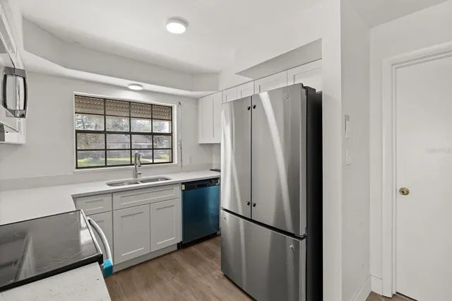 a kitchen with stainless steel appliances a refrigerator and a sink