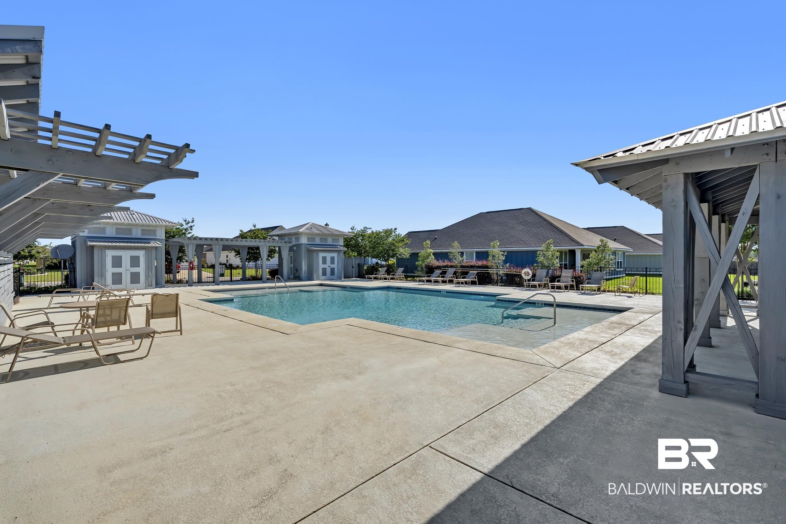 1228 Caper Avenue Foley, AL 36535 - Photo 37 of 54 Community swimming pool featuring a rectangular shape and integrated steps