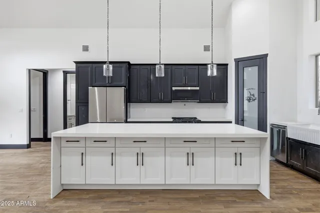 a kitchen with stainless steel appliances granite countertop a white cabinets and a granite counter tops