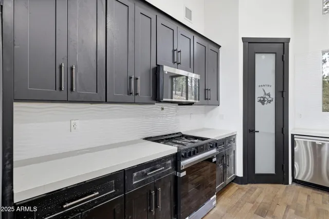 a kitchen with wooden cabinets and a stove top oven
