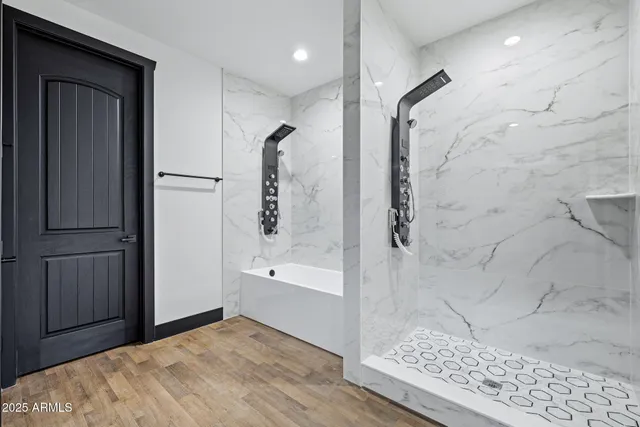 a bathroom with a bathtub and a shower