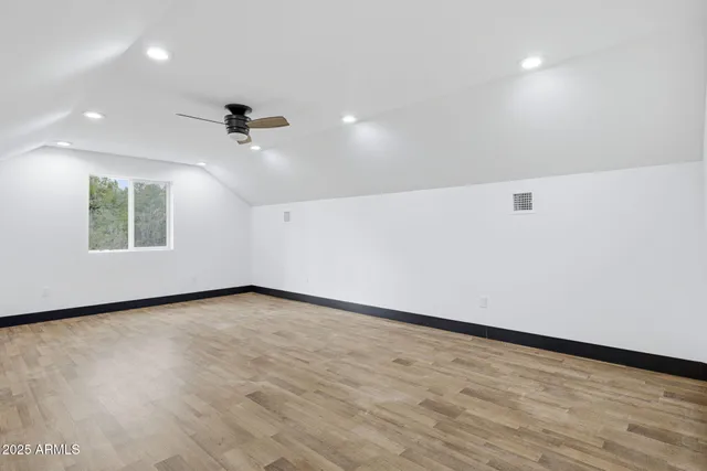 an empty room with a empty space and windows