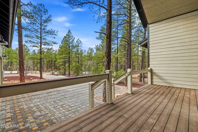 a view of a balcony with wooden floor and outdoor space