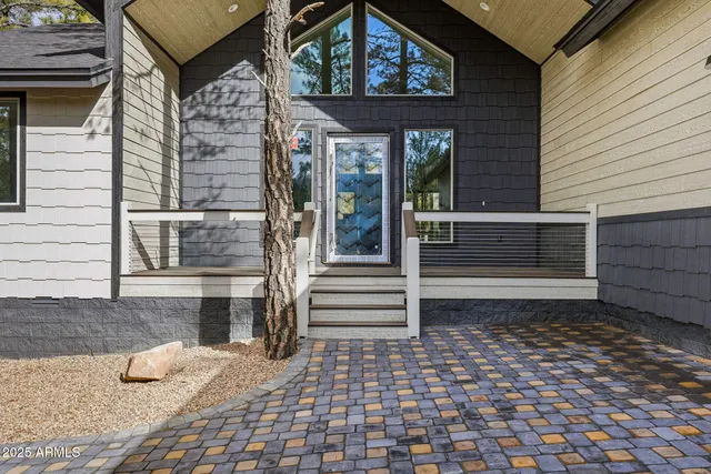 a front view of a house with a door and wooden floor