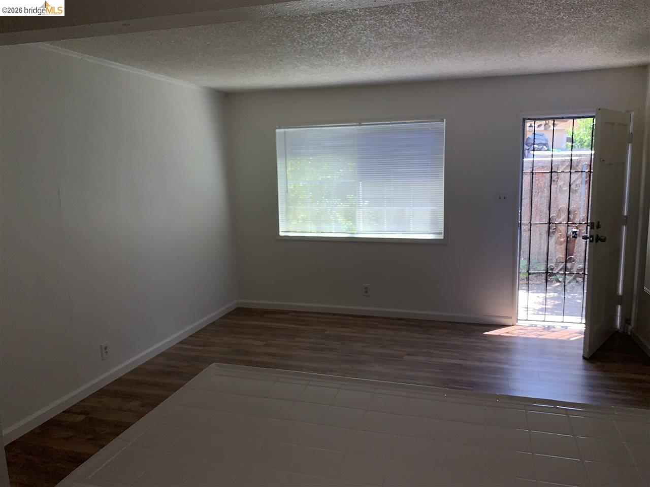 124 West 8th Street, Unit B Tracy, CA 95376 - Photo 11 of 11 an empty room with wooden floor and windows
