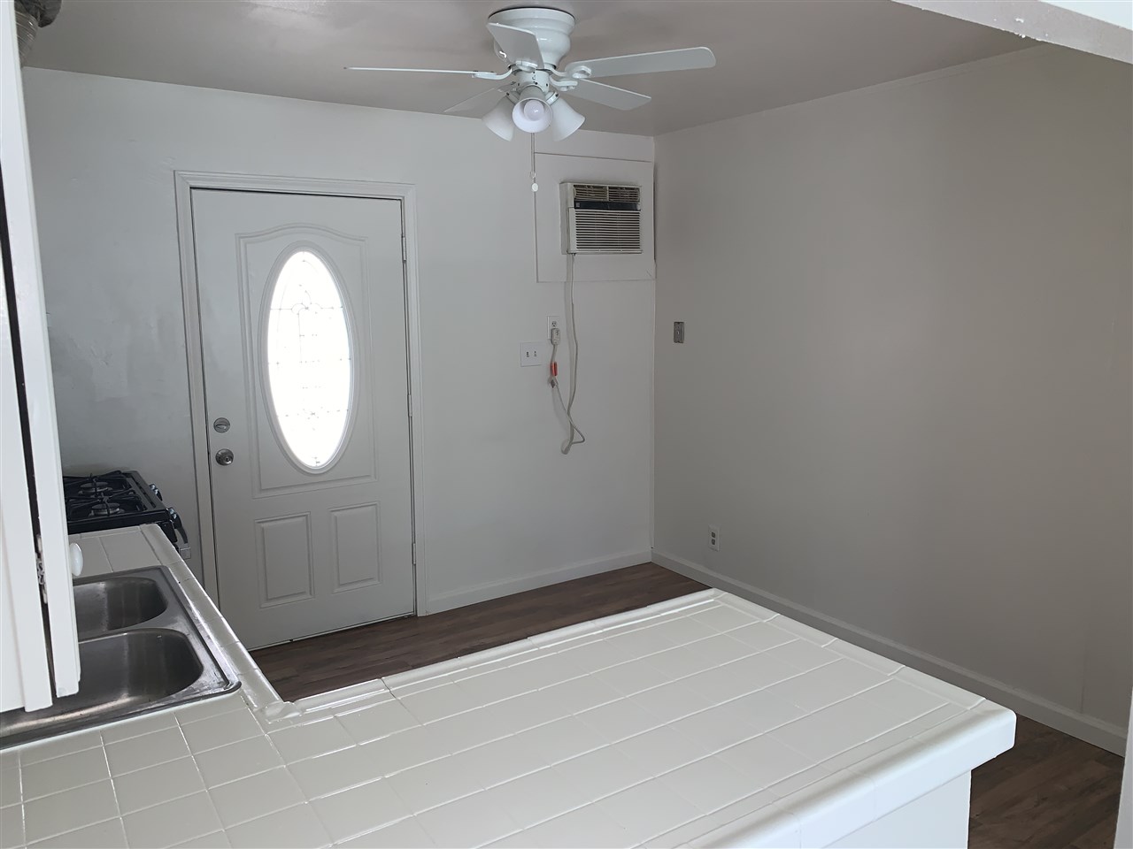 124 West 8th Street, Unit B Tracy, CA 95376 - Photo 3 of 11 a room with cabinets and a wooden floor