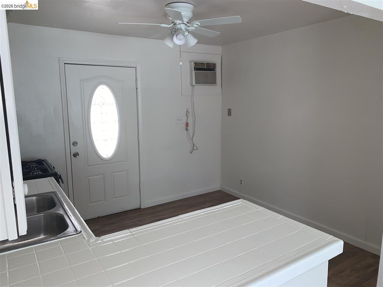 124 West 8th Street, Unit B Tracy, CA 95376 - Photo 3 of 11 a room with cabinets and a wooden floor