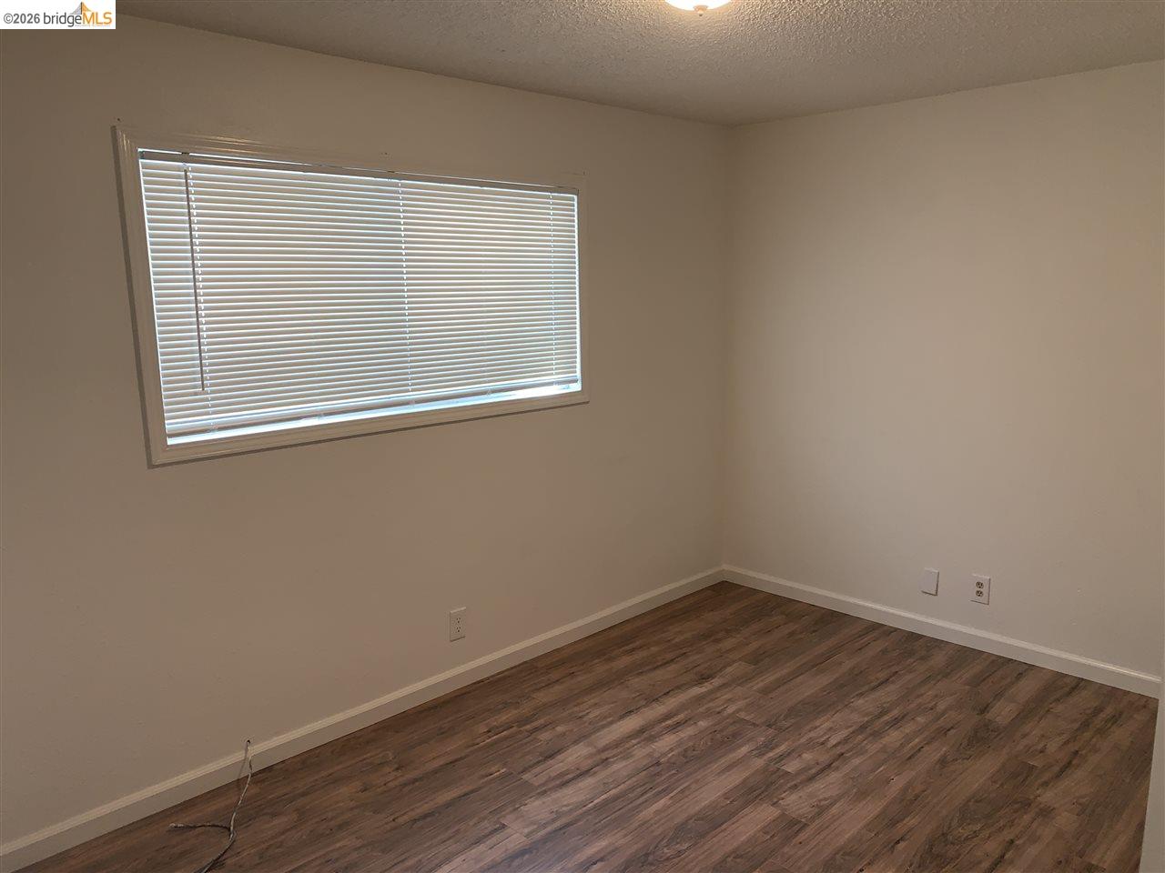 124 West 8th Street, Unit B Tracy, CA 95376 - Photo 4 of 11 an empty room with a window