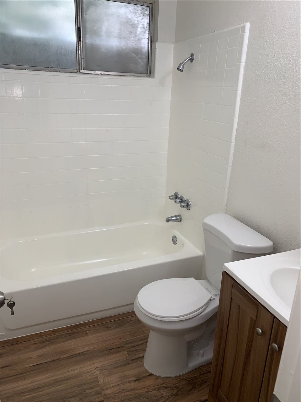 124 West 8th Street, Unit B Tracy, CA 95376 - Photo 6 of 11 a white toilet sitting next to a bath tub