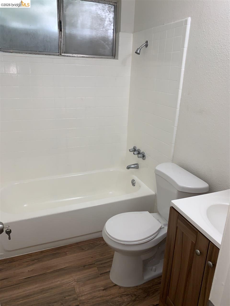 124 West 8th Street, Unit B Tracy, CA 95376 - Photo 6 of 11 a white toilet sitting next to a bathroom sink and vanity