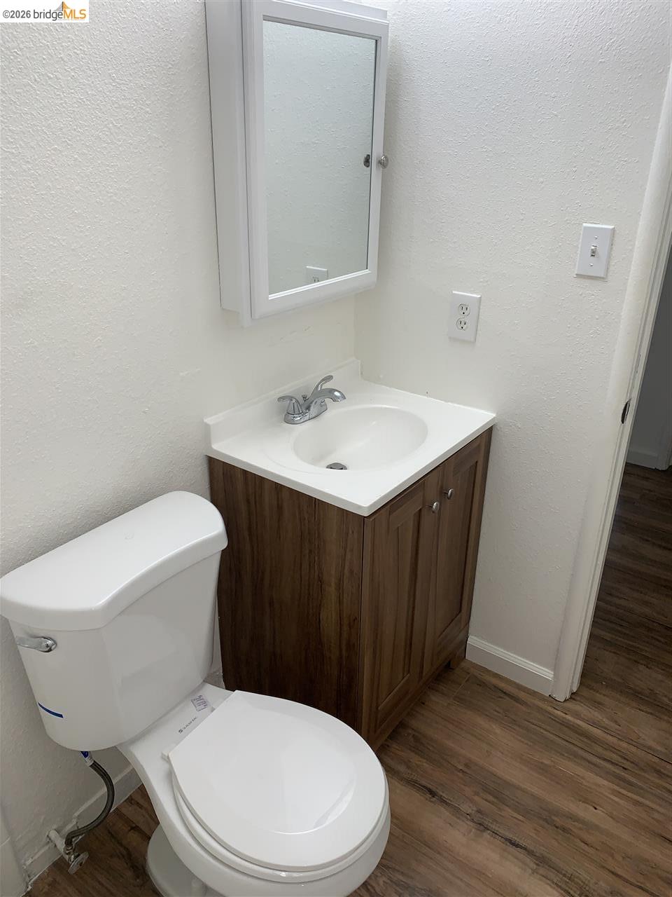 124 West 8th Street, Unit B Tracy, CA 95376 - Photo 7 of 11 a white toilet sitting next to a bathroom sink