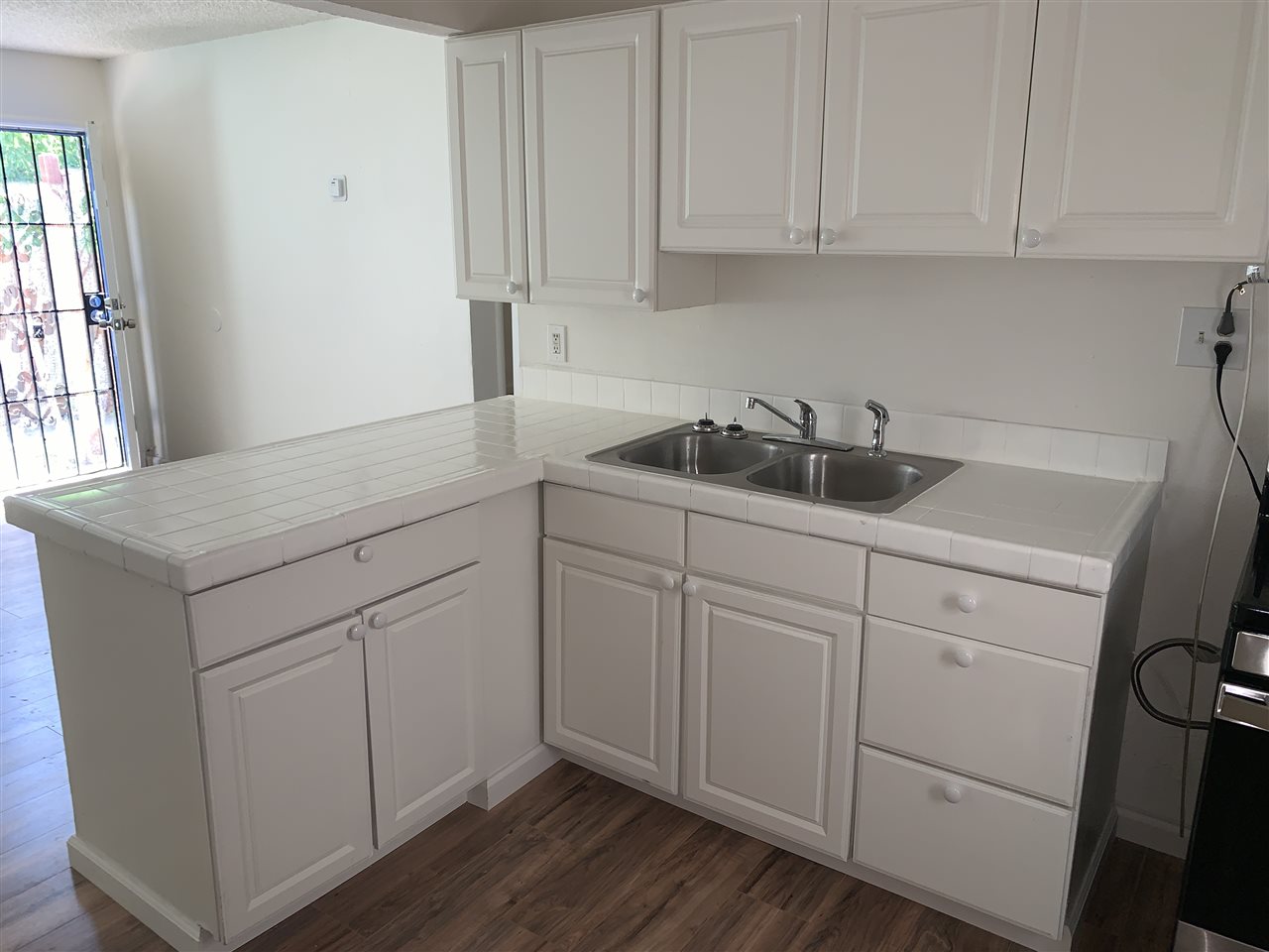 124 West 8th Street, Unit B Tracy, CA 95376 - Photo 10 of 11 a kitchen with white cabinets and sink