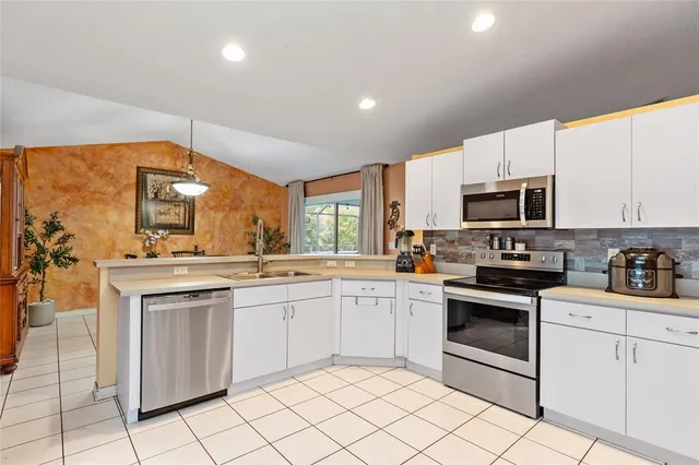 a kitchen with a sink stove and refrigerator