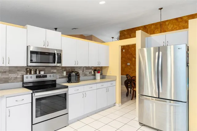 a view of a dining room with furniture and chandelier