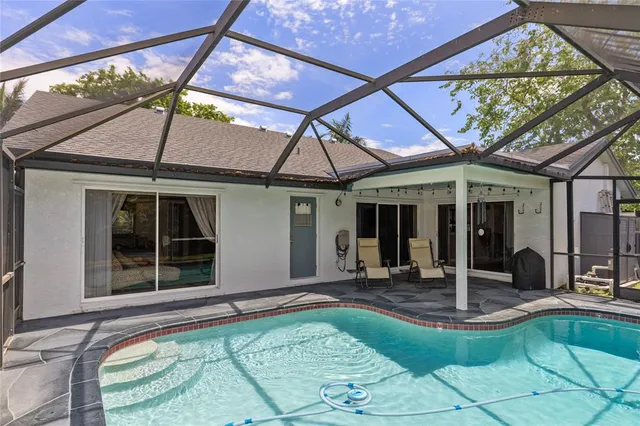 a front view of a house with swimming pool and a yard