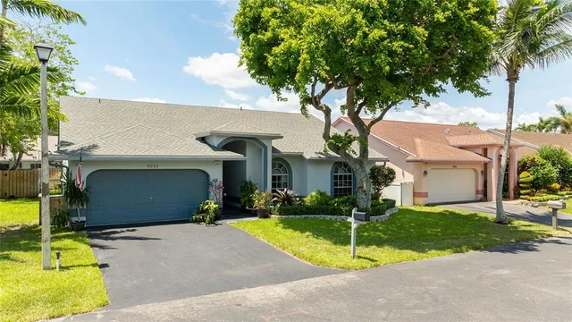 an aerial view of a house with swimming pool and porch