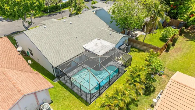 an aerial view of a house with swimming pool